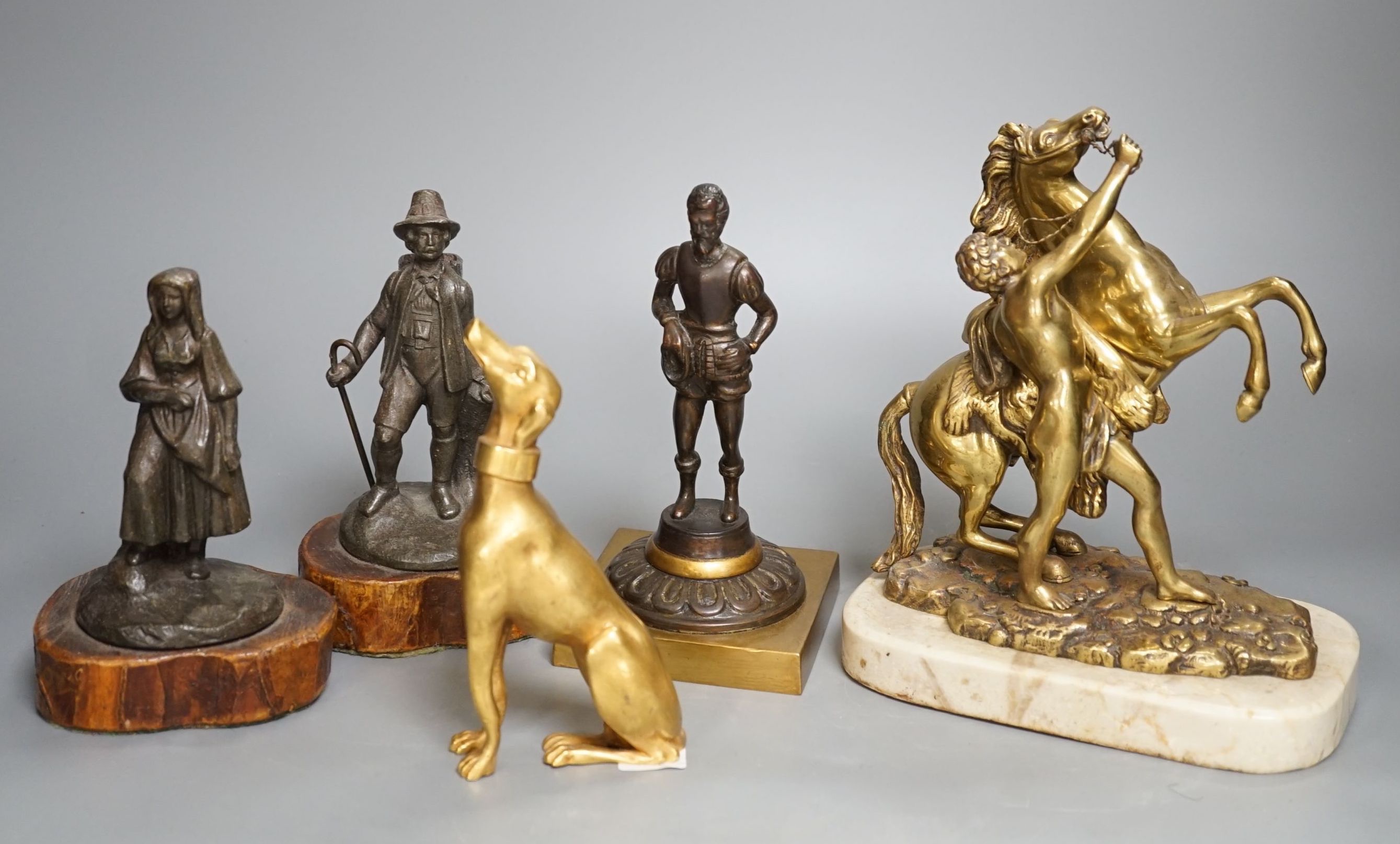 A brass Marly horse group , three decorative metal figures and a gilt bronze figure of a whippet (5)